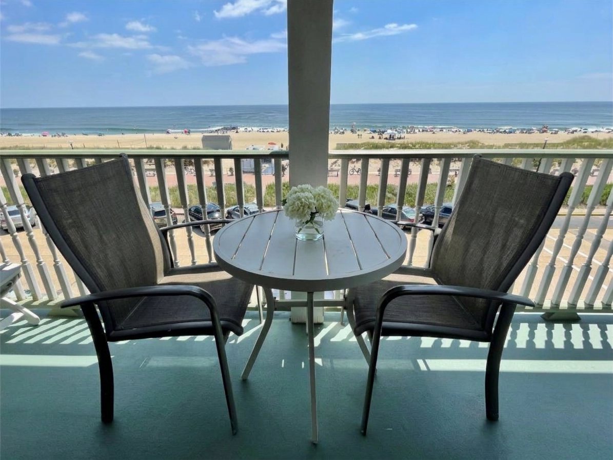 Oceanfront balcony with white hydrangeas on the table at the Laingdon Hotel, overlooking the Ocean Grove beach